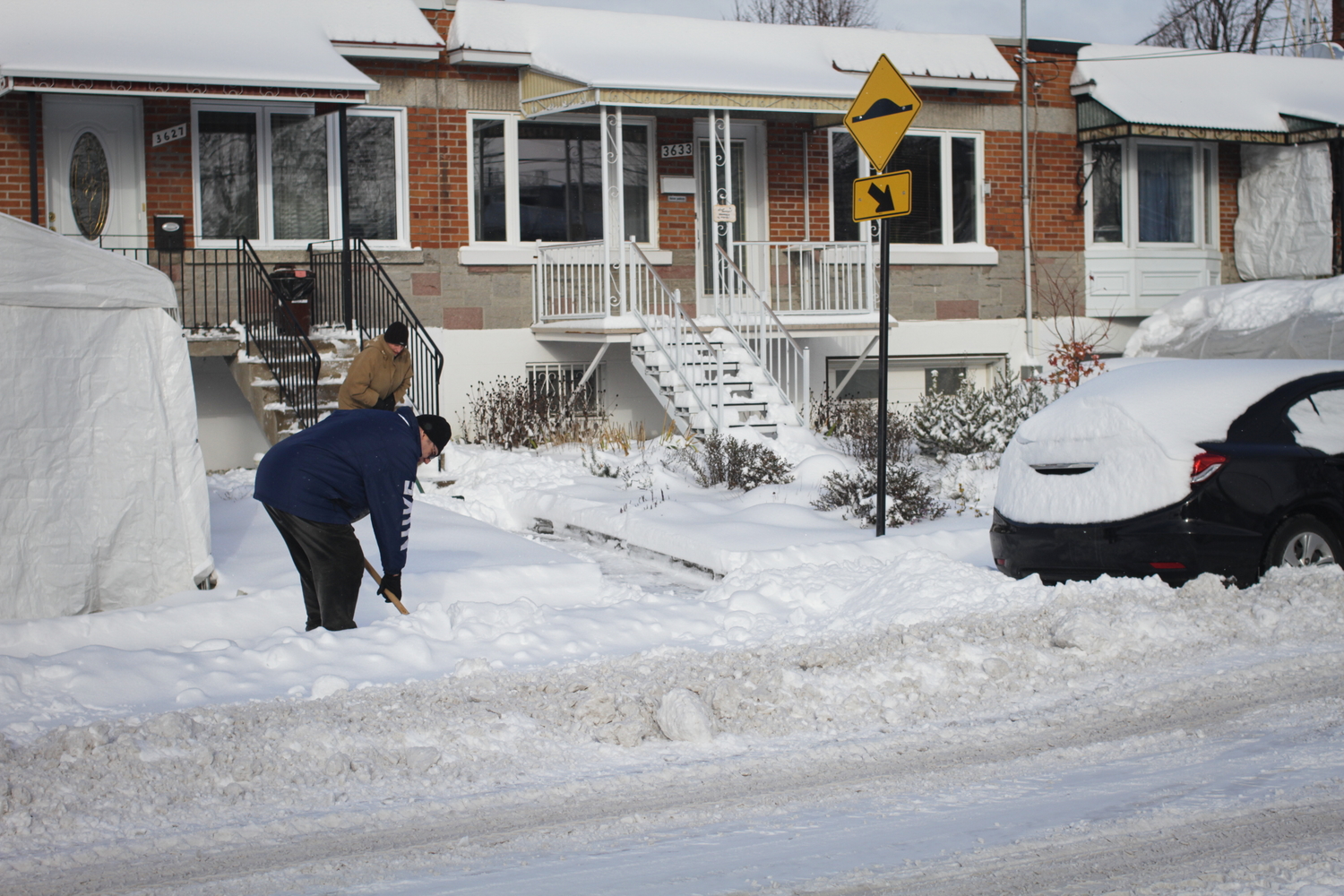 Les voisins déblaient la neige. 